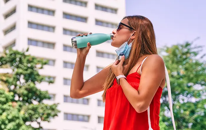 Masked Woman Hydrating