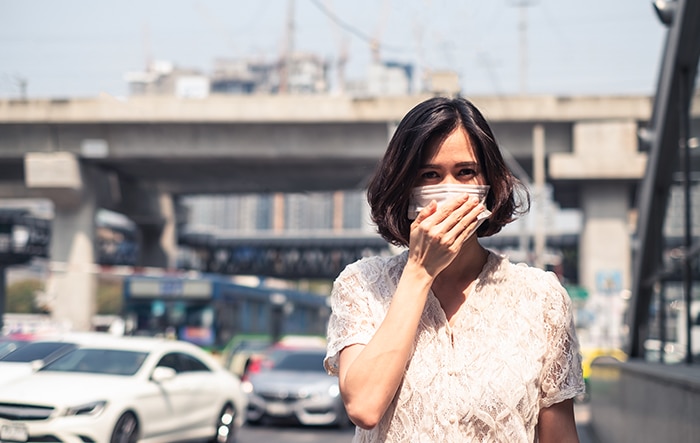 Woman Standing in Polluted Air