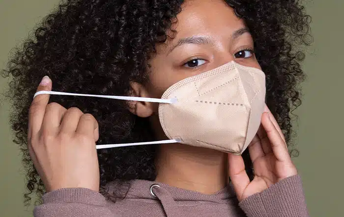 Girl Putting On a Face Mask